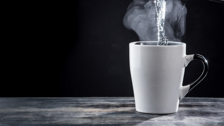 Boiling water being poured into mug