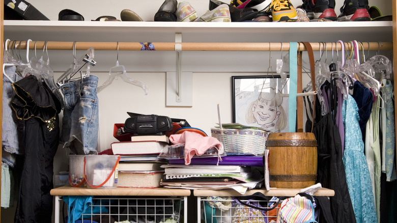 messy closet with hangers and clothes