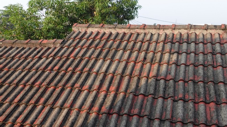 Faded concrete roof tiles on a home