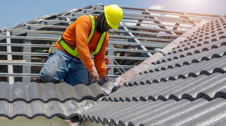 Worker installing tiles