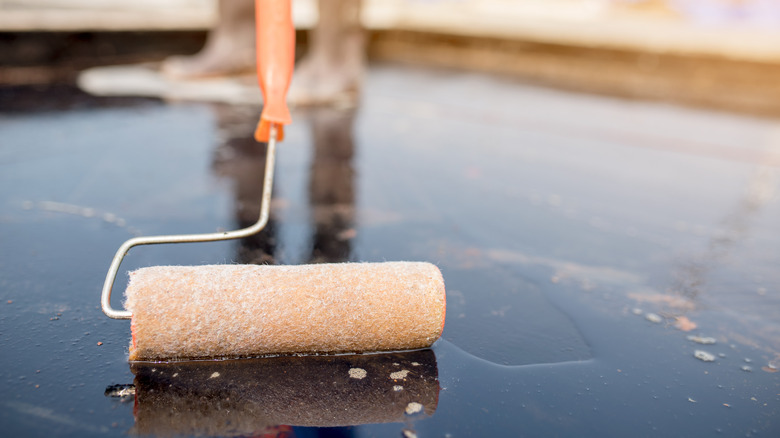 Applying glue remover to floor