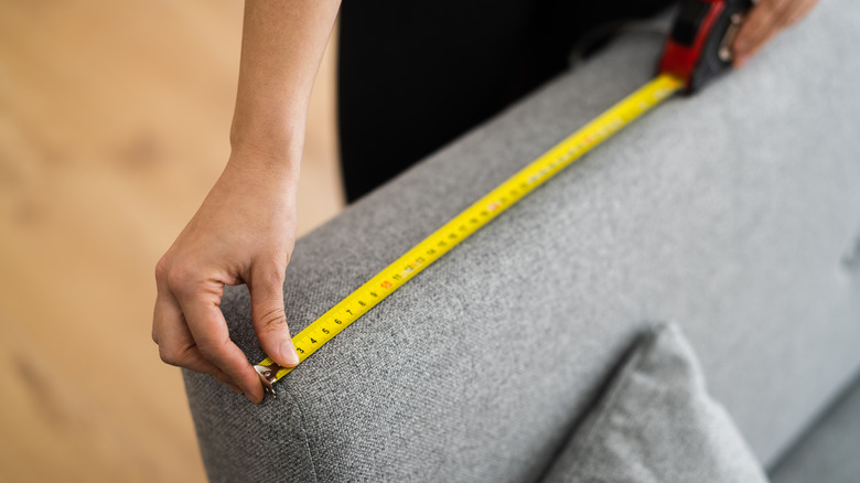 Person measuring a couch