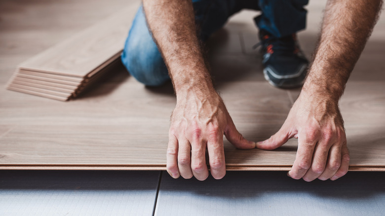 Man installing flooring