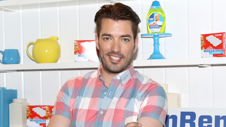 Jonathan Scott smiling in front of shelves with pottery and Mr. Clean products