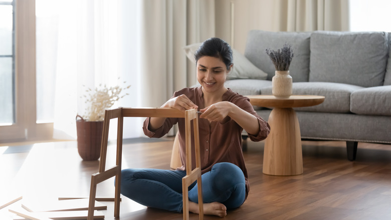 woman assembling furniture