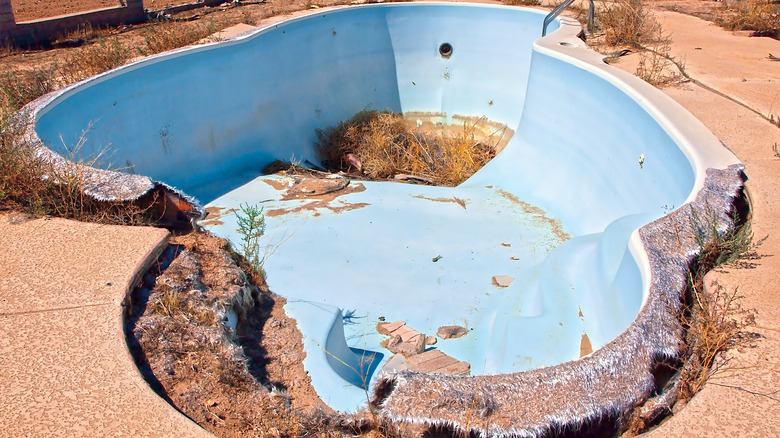 Broken, abandoned fiberglass pool