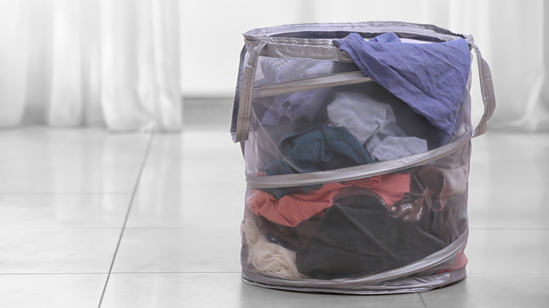 Gray collapsible laundry basket on ground