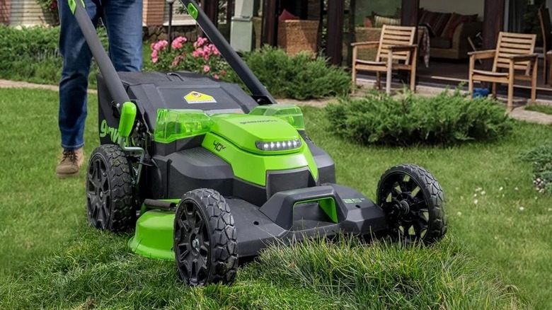 person walking behind Greenworks mower