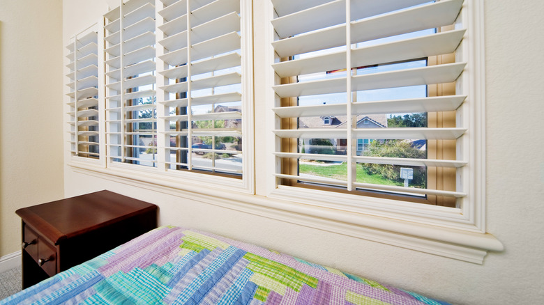 Faux wood shutters in bedroom