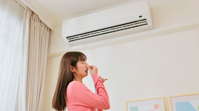 Woman sensing bad AC smell