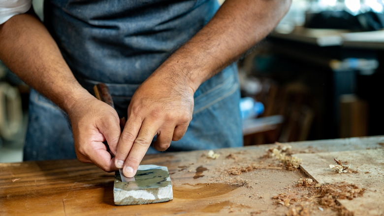 woodworker freehand sharpening a chisel