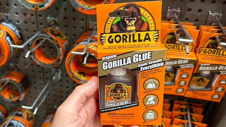 Someone holding up original gorilla glue at a store