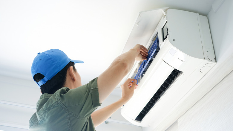 Person repairing AC unit