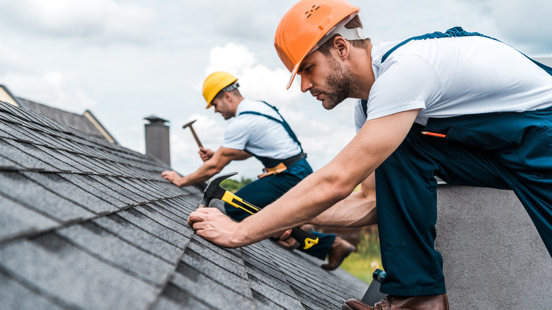 men building roof