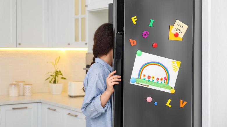 woman opening fridge