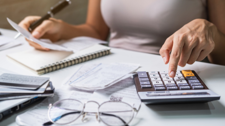 woman calculating escrow shortages