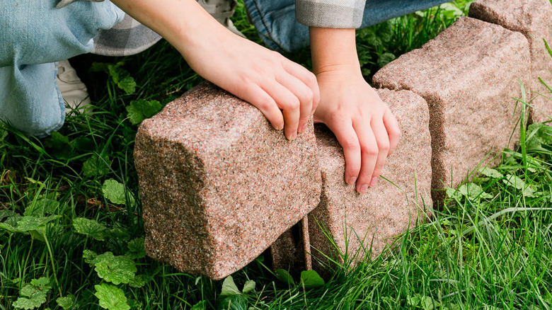 Woman slotting Beuta faux stone blocks together