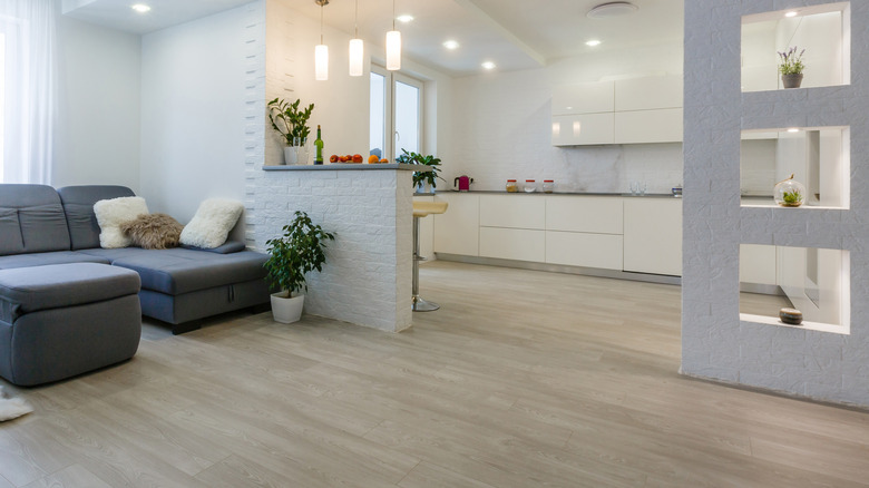 A living room and kitchen with white oak floors