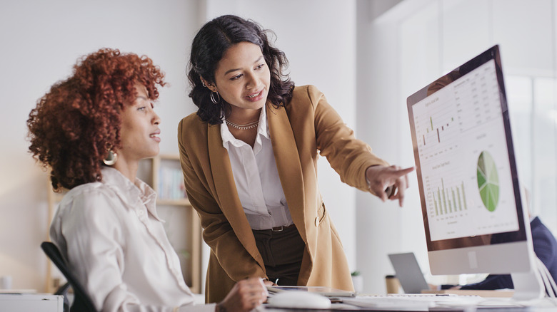 Women looking at computer analytics