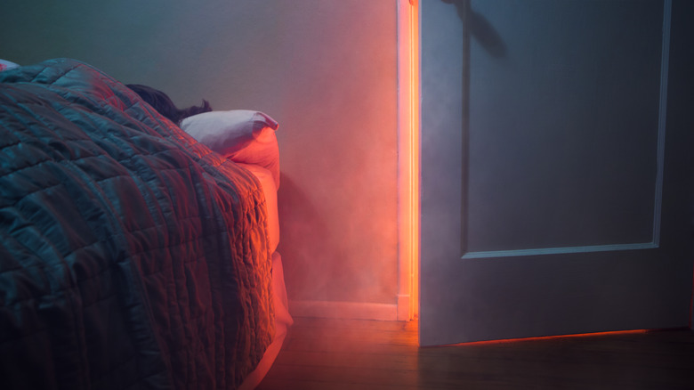 bedroom with smoke coming out of door