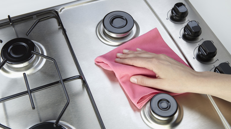 hand cleaning stainless steel stove 