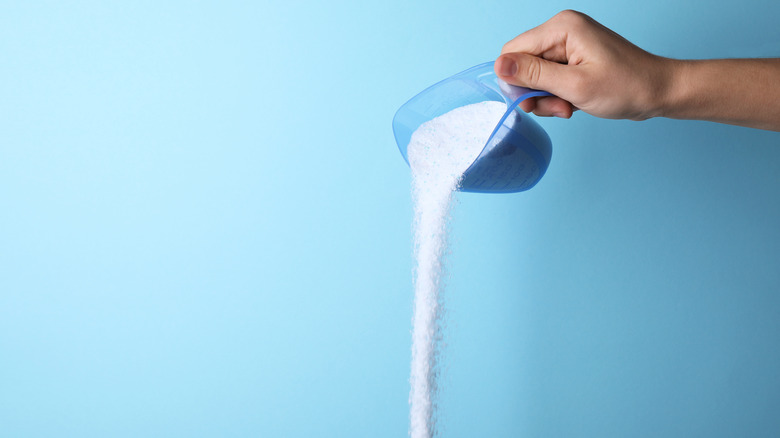 Pouring laundry detergent