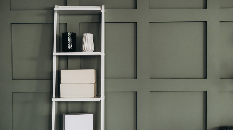 Shelving leaning against wall paneling