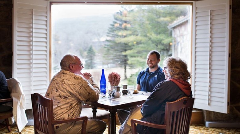 three people sitting around a table 