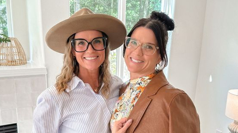 Lyndsay Lamb and Leslie Davis stand together smiling.