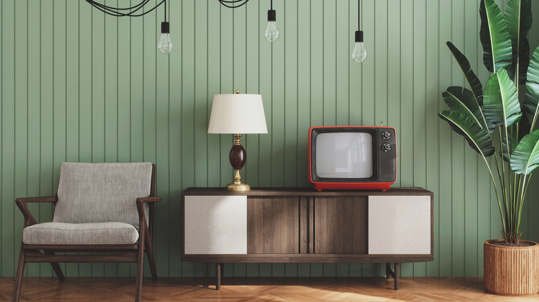 A television in a living room with mid-centry modern decor.