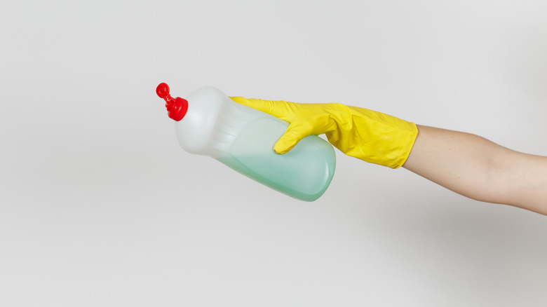 hand holding cleaning detergent