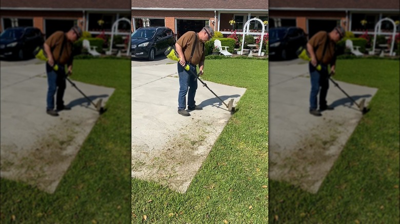 man edging a driveway with Ryobi trimmer