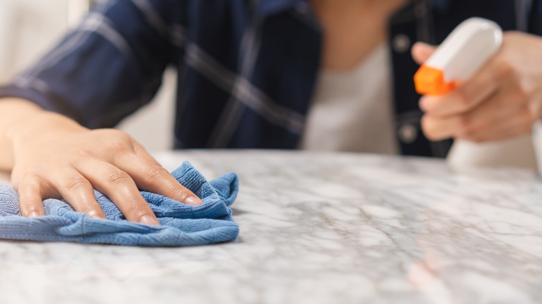 Person cleans counter with cloth