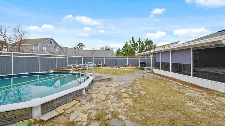 Round paved pool in backyard 