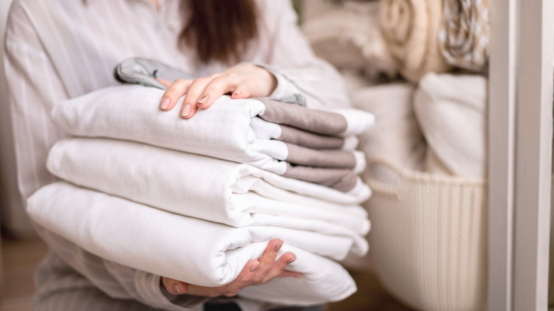 woman holding folded linen