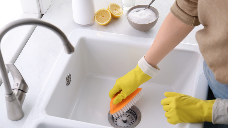 person cleaning kitchen sink