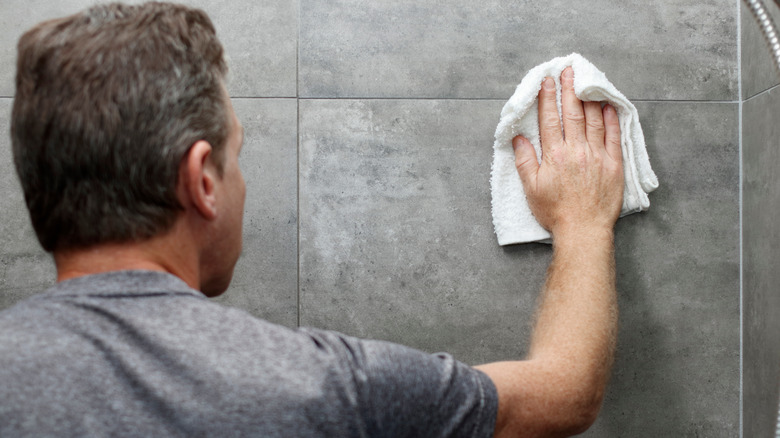 wiping slate tile in shower