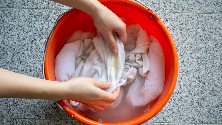 stained clothes soaking in bucket