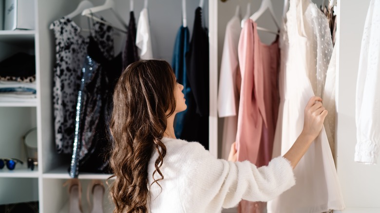 woman picking outfit from closet