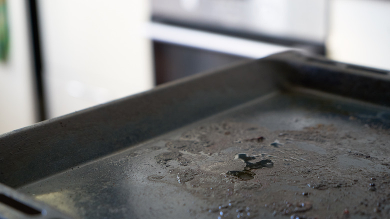 Dirty baking tray with kitchen background