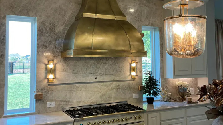 Kitchen with brass range hood