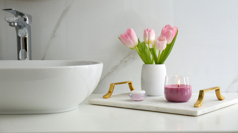 candle and flowers in bathroom