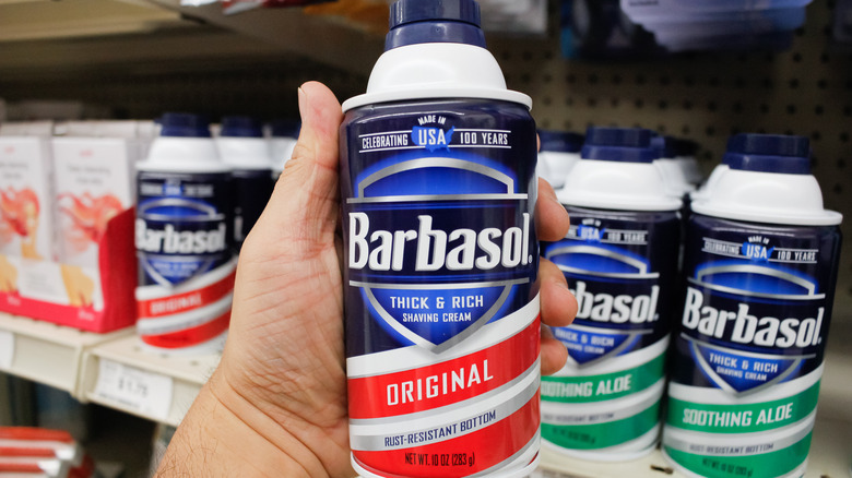 Hand holding can of Barbasol 