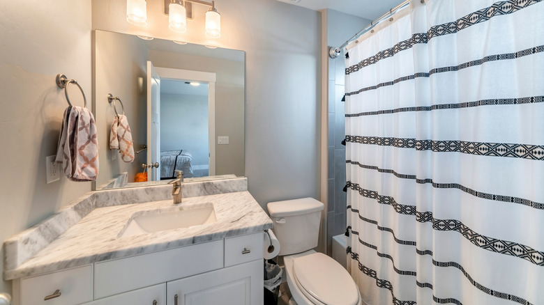 Bathroom with closed shower curtain