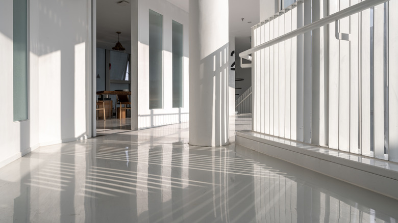 room with large bright windows and polished concrete floor