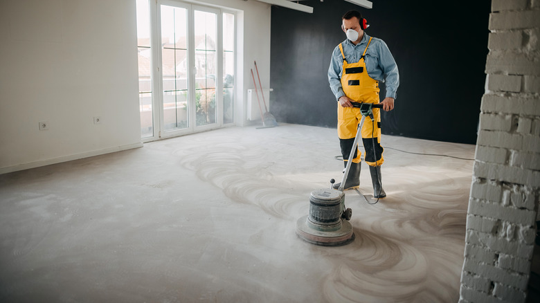 man buffing an interior concrete floor