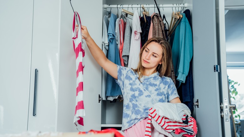 person decluttering their closet