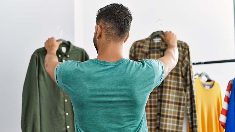 man organizing clothes