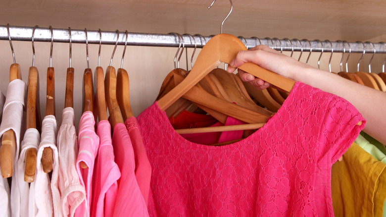 hanging clothing on wooden hanger