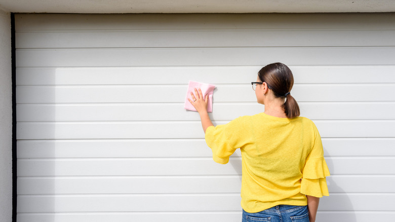 woman wiping garage door